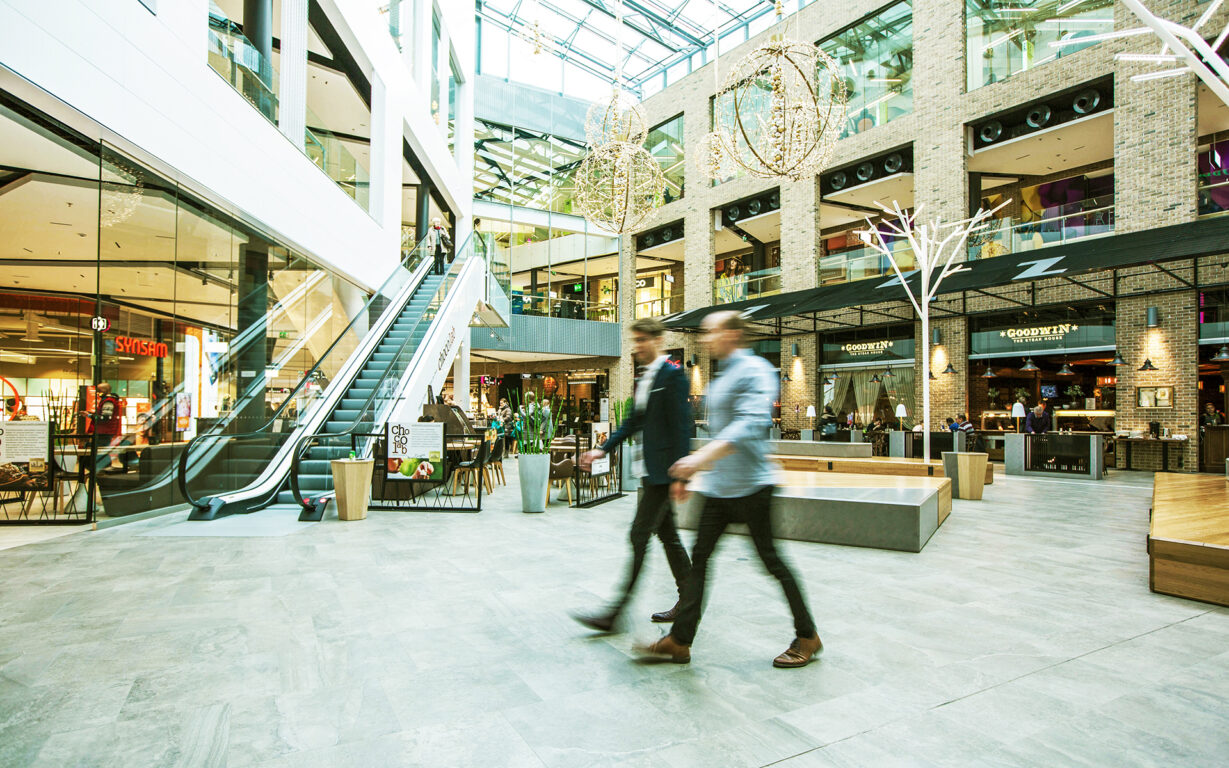 Men walking in a Citycon shopping centre.