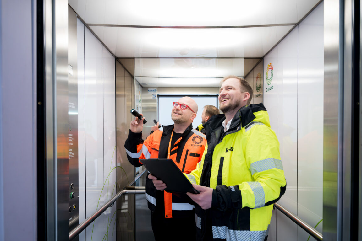 Granlund's Mika Virkki and Kiwa's Jaakko Tuukkanen checking the inspection details for an elevator.