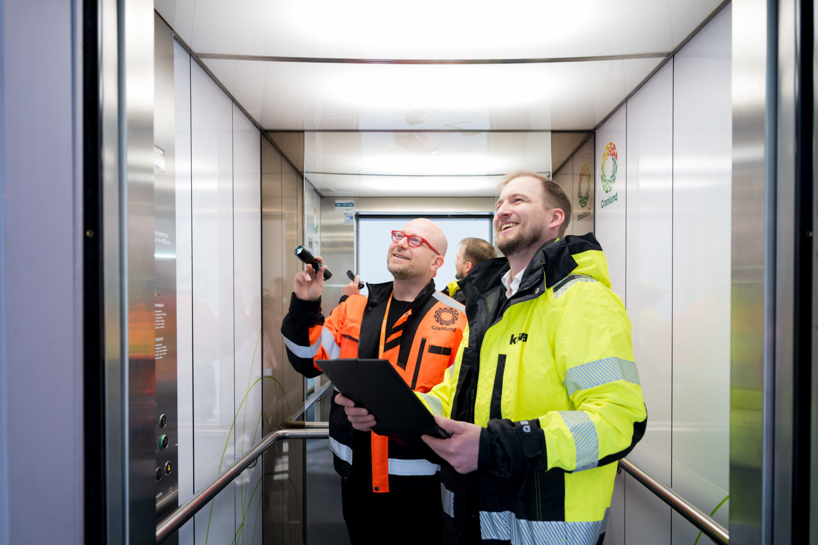 Granlund's Mika Virkki and Kiwa's Jaakko Tuukkanen checking the inspection details for an elevator.